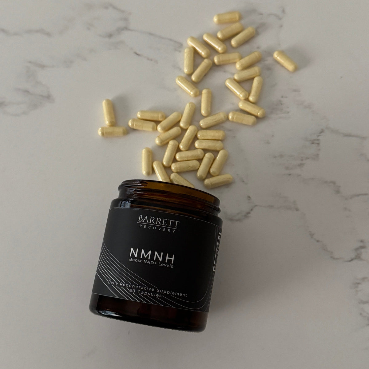 Black bottle of NMNH with gold capsules on a marble surface