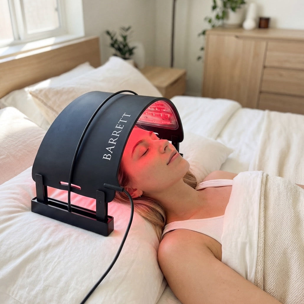 Woman using a Barrett hair treatment device in her bedroom.