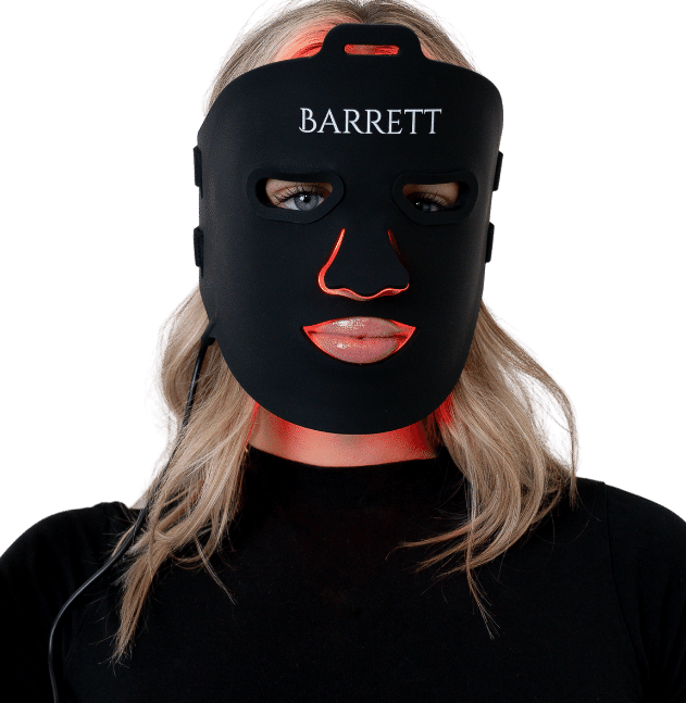 Barrett red light therapy mask by barrett recovery on a blonde haired woman's face