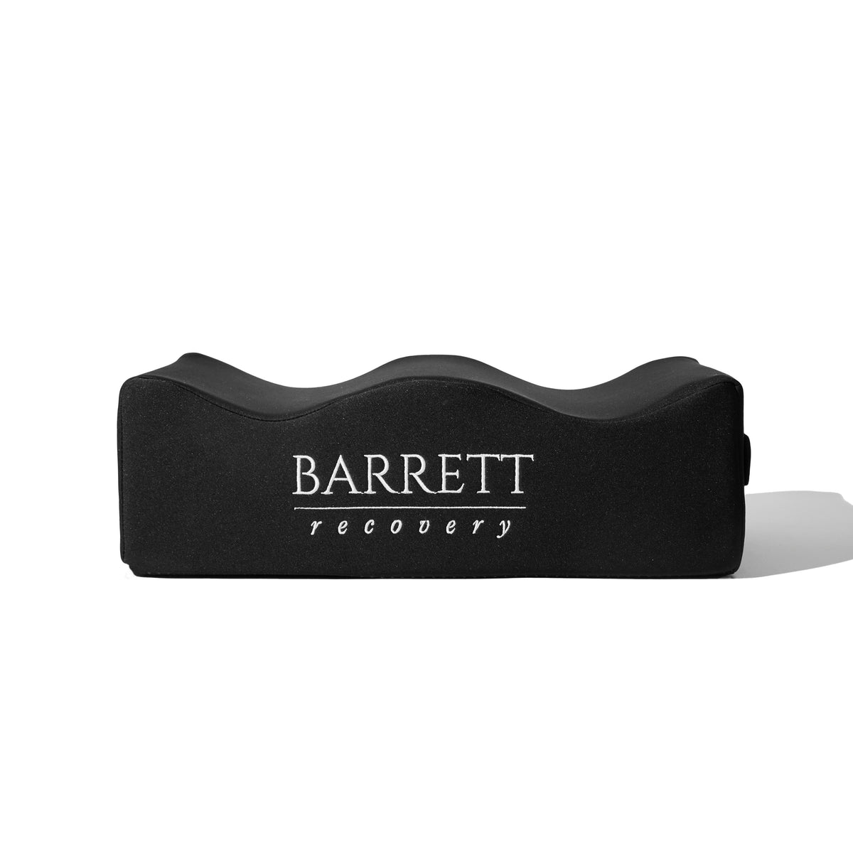 A black memory foam pillow with the Barrett Recovery logo on the front for bbl surgery after care