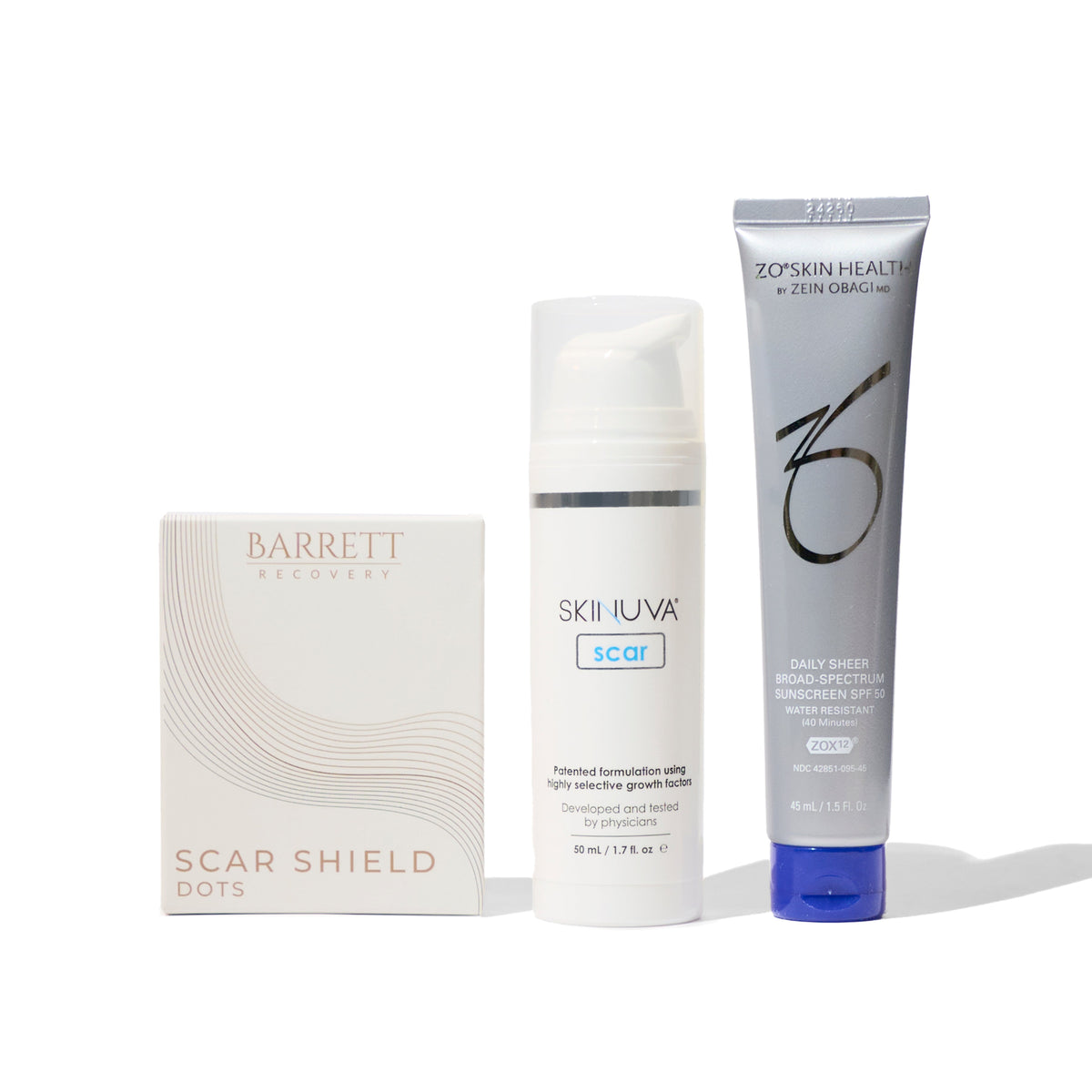 A collection of products for scar management including a bottle labeled 'Barrett', a tube labeled 'Skinuva', and a box labeled 'Scar Shield'.