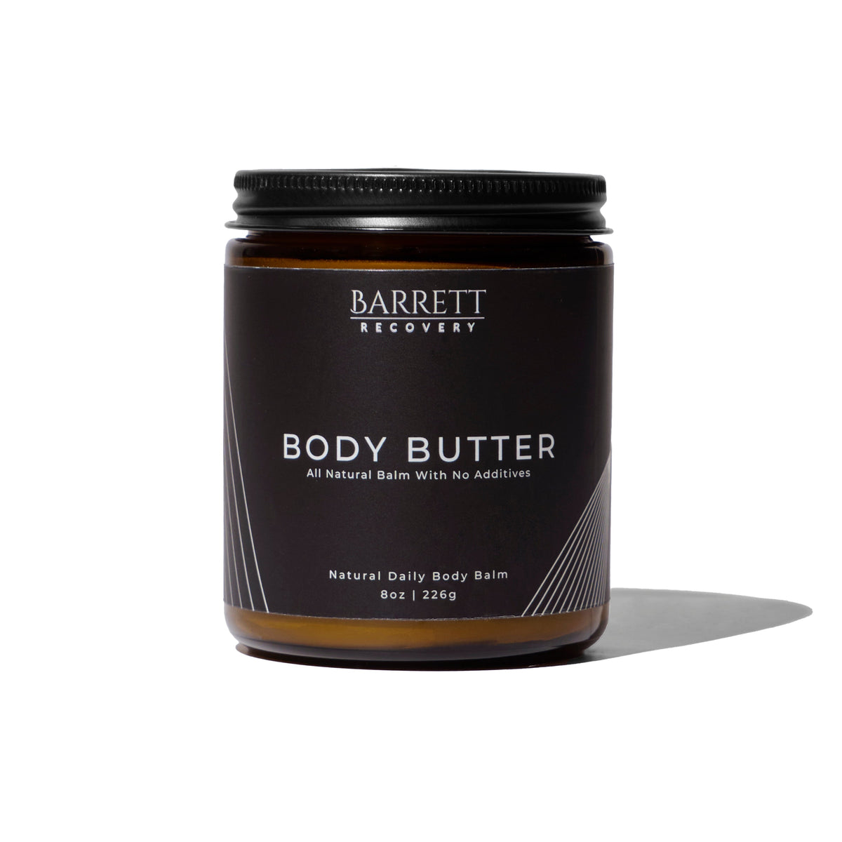 A jar of Barrett Recovery Body Butter on a clean white background with a soft shadow. The jar is dark brown glass with a black lid and a black label featuring white text.
