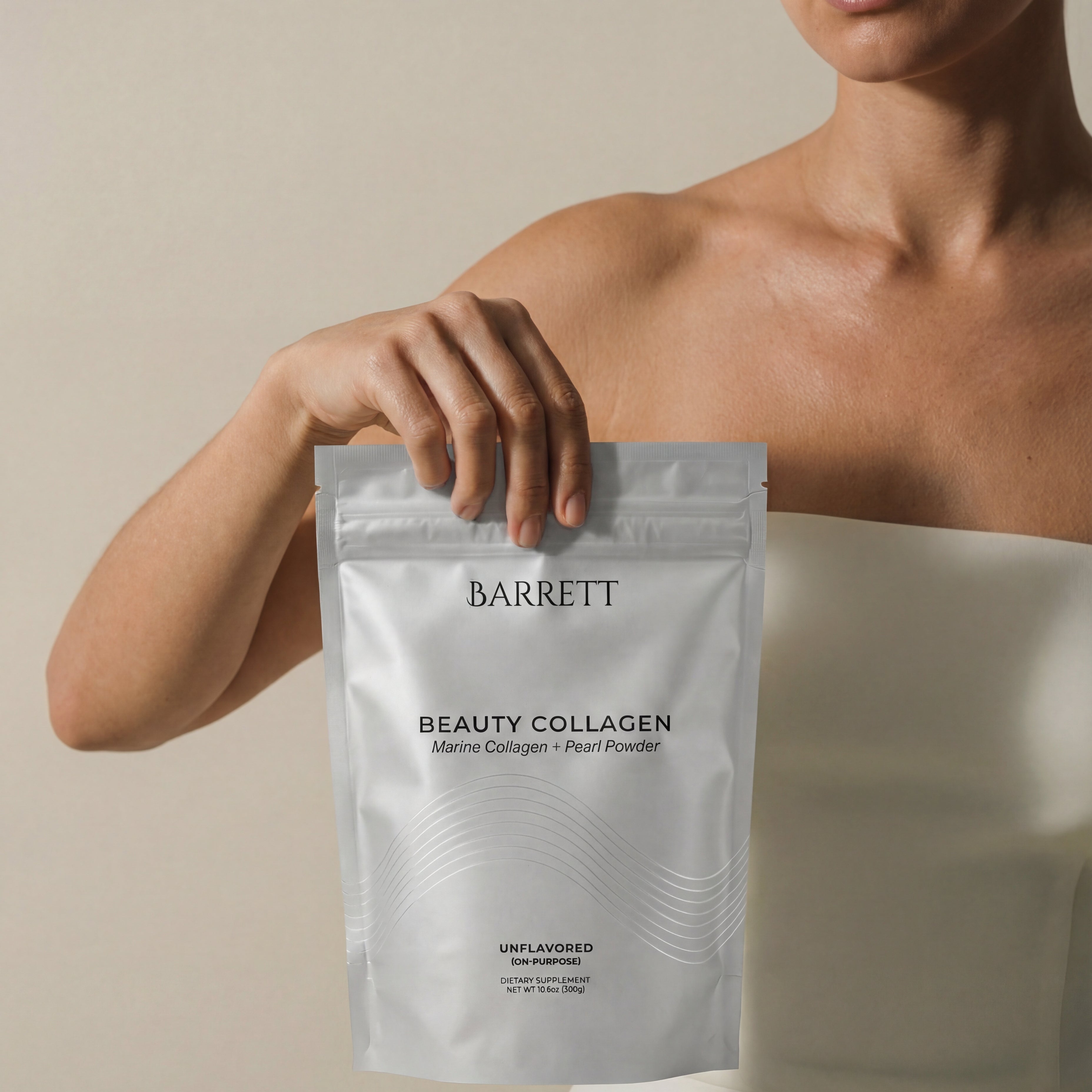 Person holding a Barrett Beauty Collagen package against a neutral background