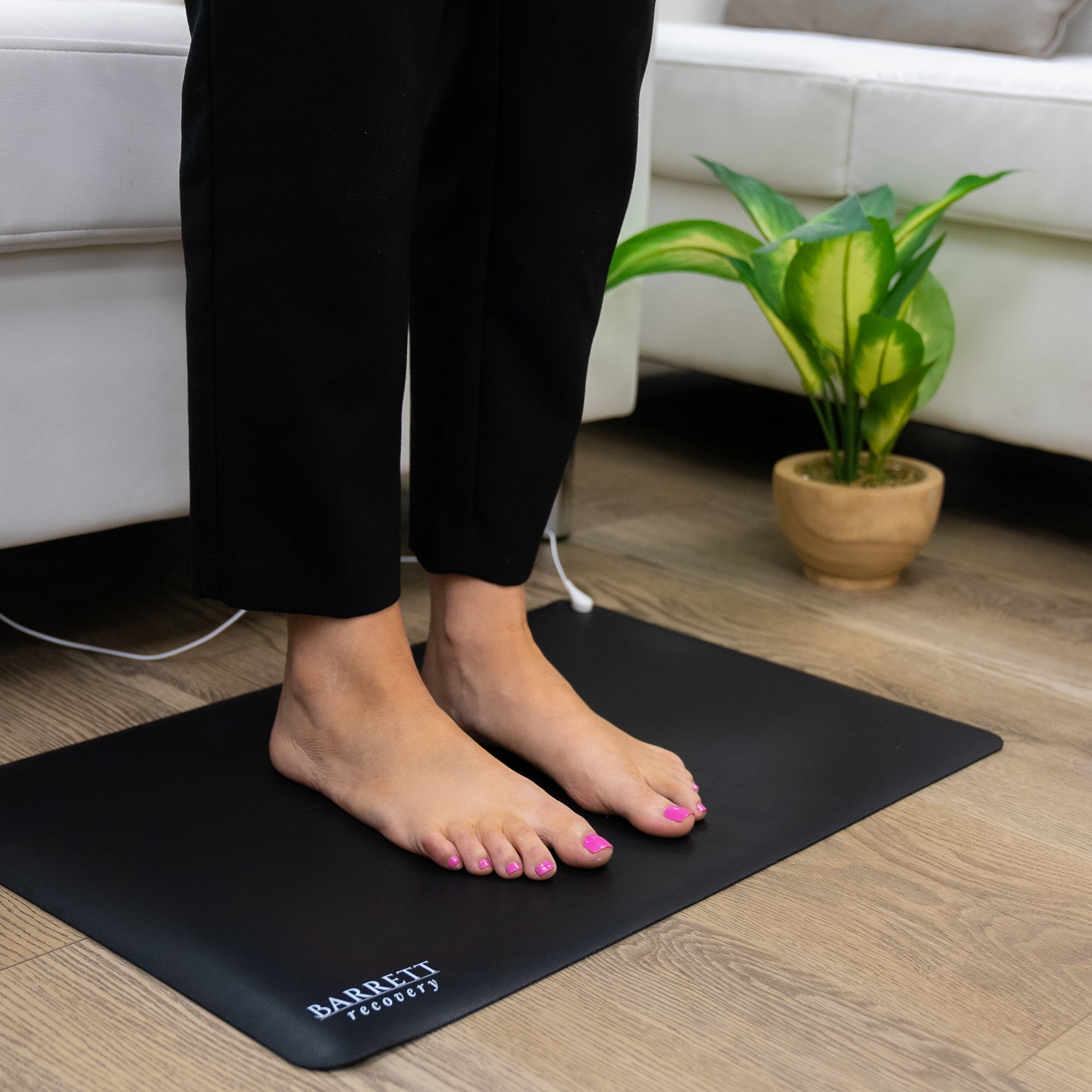 Barrett Recovery ground mat with feet laying on top of mat